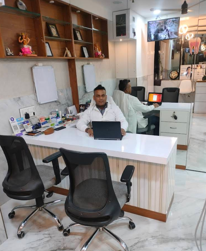 Dr. Amar Hegde at the consultation desk inside Borivli Smiles Dental Clinic